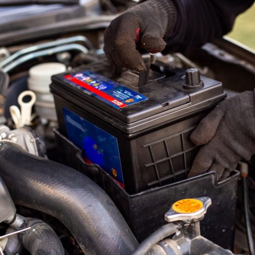 Replacing,A,Car,Battery.,A,Man,Installs,A,Battery,In